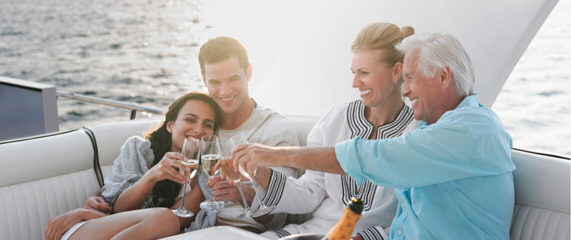 Two couples drinking champagne on a boat