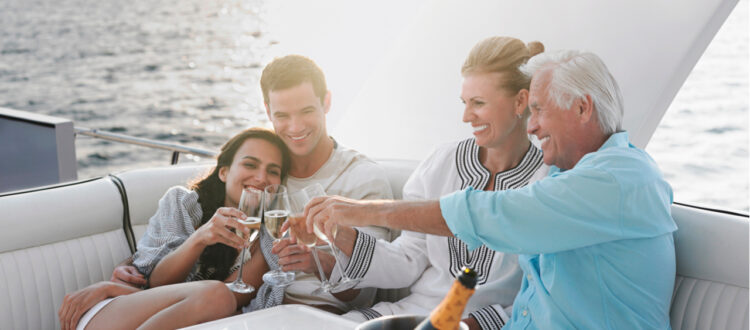 Two couples drinking champagne on a boat