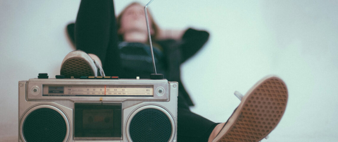 Woman lying with her foot on a radio